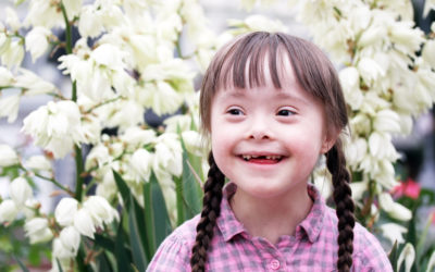 Portrait of beautiful young girl on flowers background.